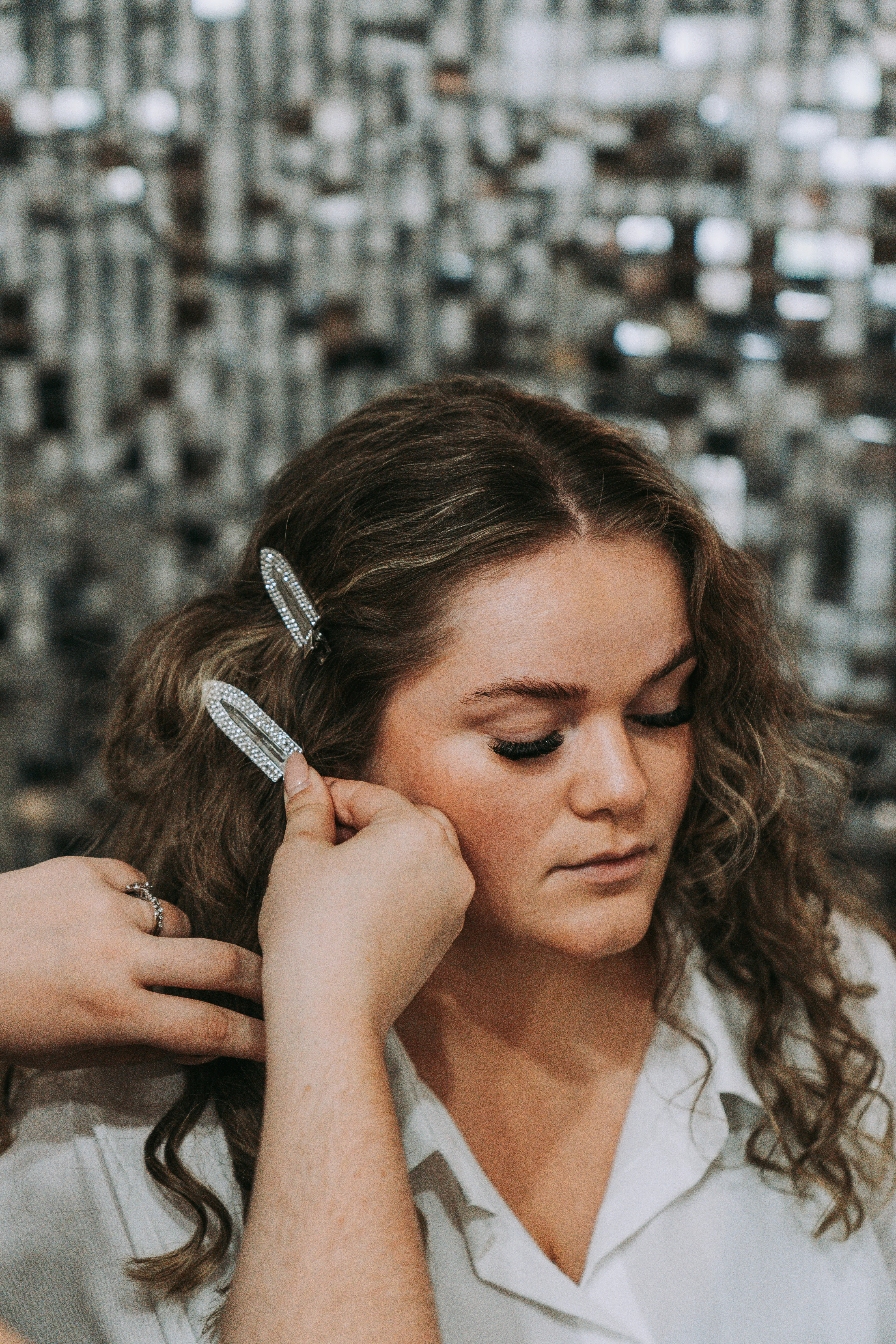 Rhinestone hair clips being placed
