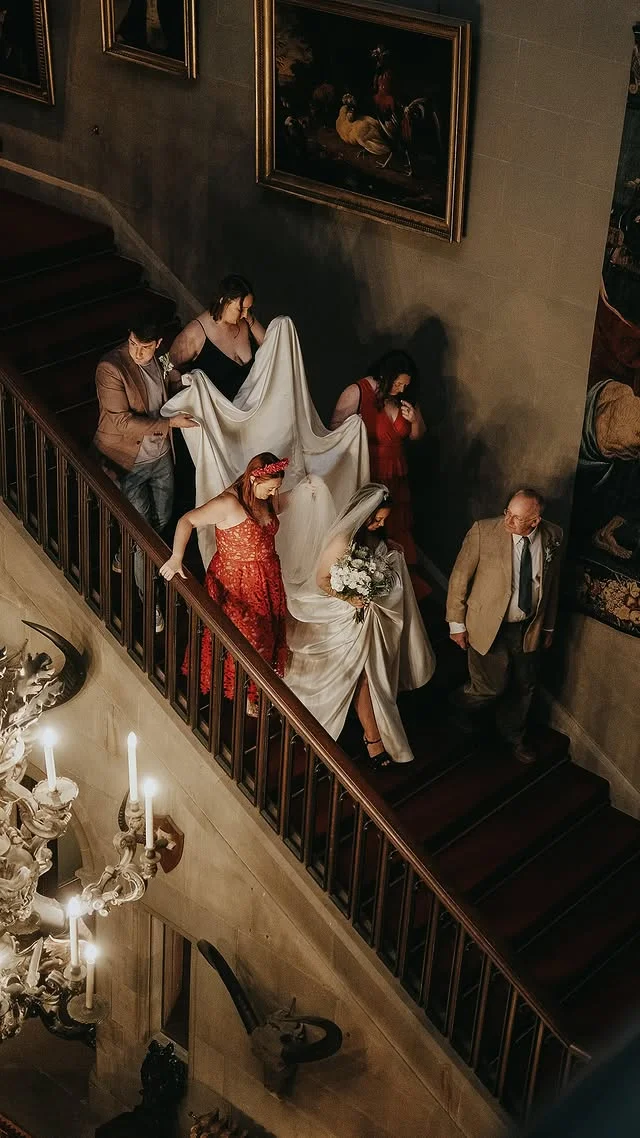 Bride descending a candlelit castle staircase
